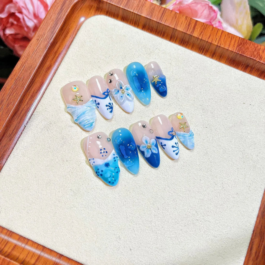 Blue hand-painted false nails with carved summer ice transparent design in sizes XS to L