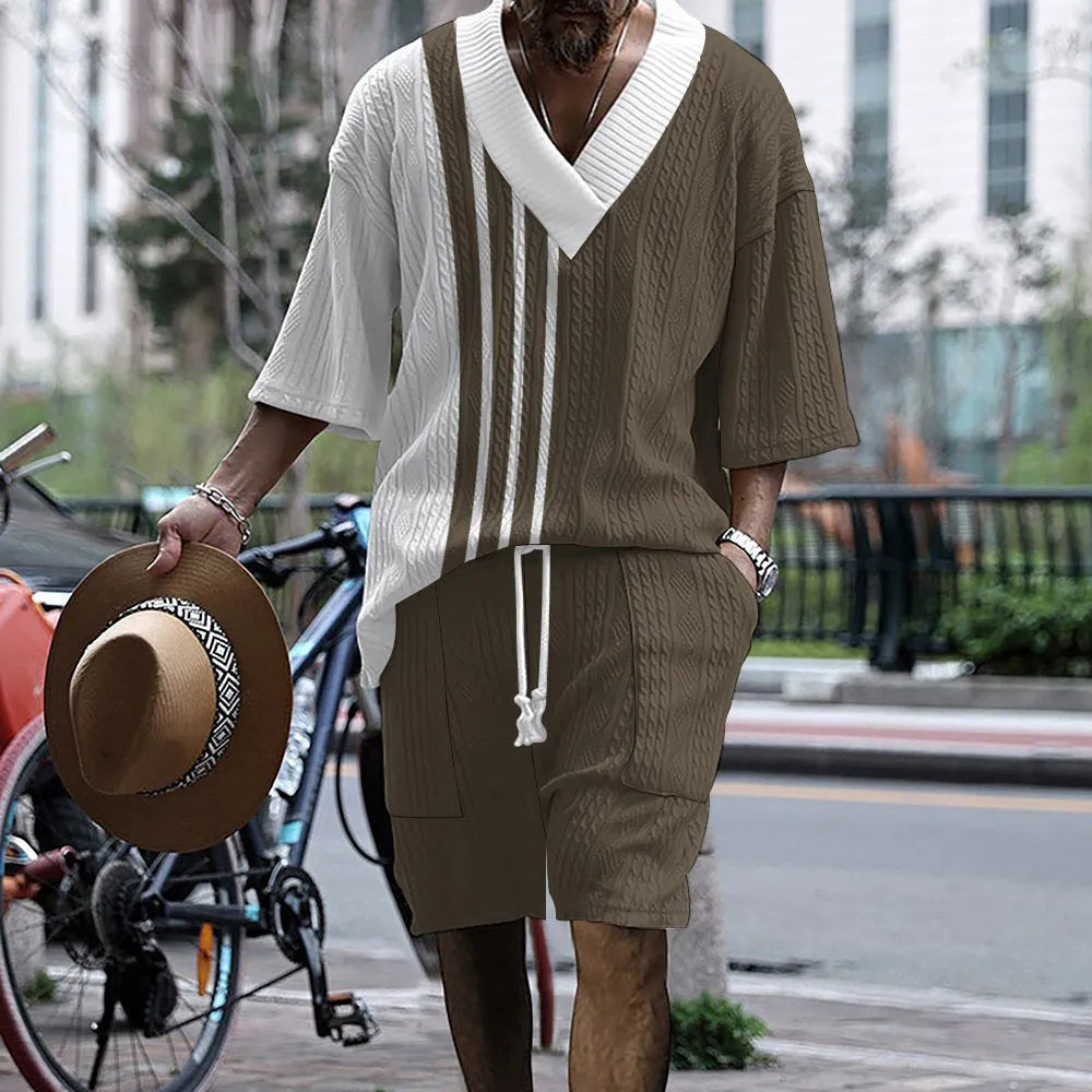 Man wearing a printed drop-shoulder knitted short-sleeve jacket with matching shorts in a casual setting.