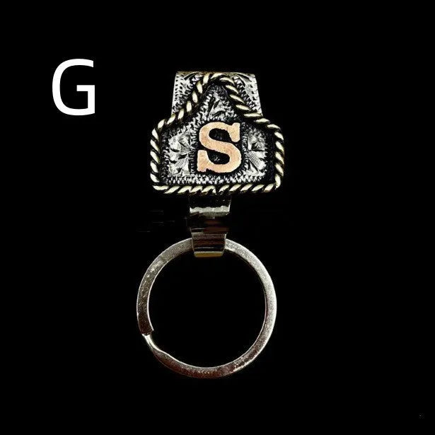 Handmade metal cow tag style key holder shown in one of its 26 colour options, attached to a keyring.