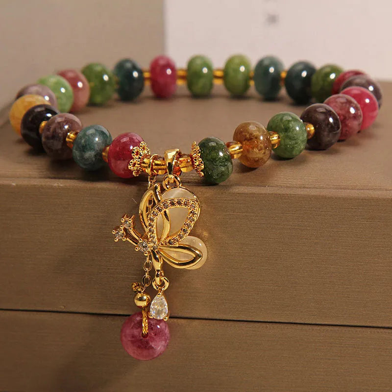 Colourful women's bracelet with a silver butterfly charm, colourful beads, and green tourmaline stones.