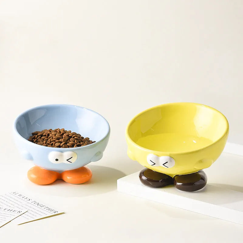 Tall blue ceramic slanted pet bowl with cute expression, designed for cervical spine support.