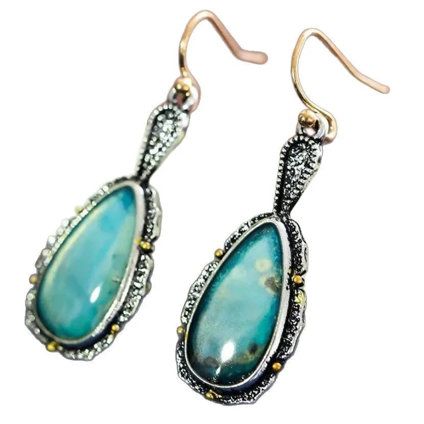 Antique silver turquoise teardrop petal drop earrings on a woman, alloy construction, vintage style
