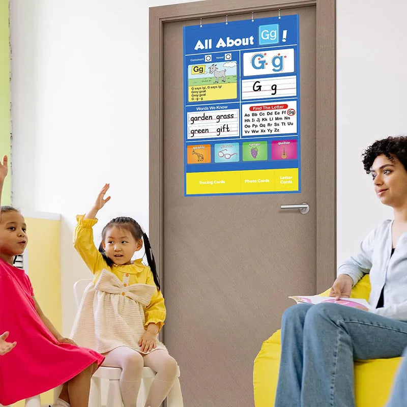 Large blue alphabet learning chart with slots for cards, surrounded by word, letter, and picture cards for children's education.