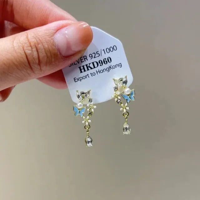 Geometric gold electroplated alloy ear clip jewellery with rhinestone and little stars tassel decoration