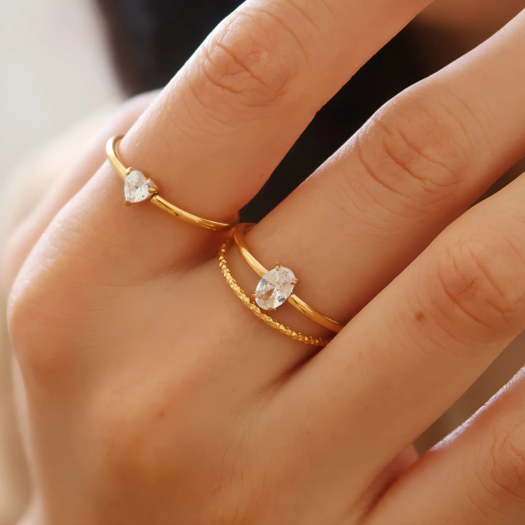 Golden electroplated stainless steel ring with love heart design, shown in sizes 5 to 8.
