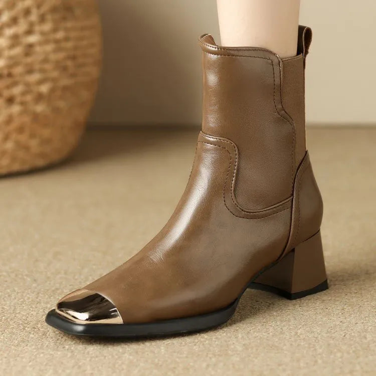 Brown cowhide leather women's Martin boots with a high heel and side zipper detail.