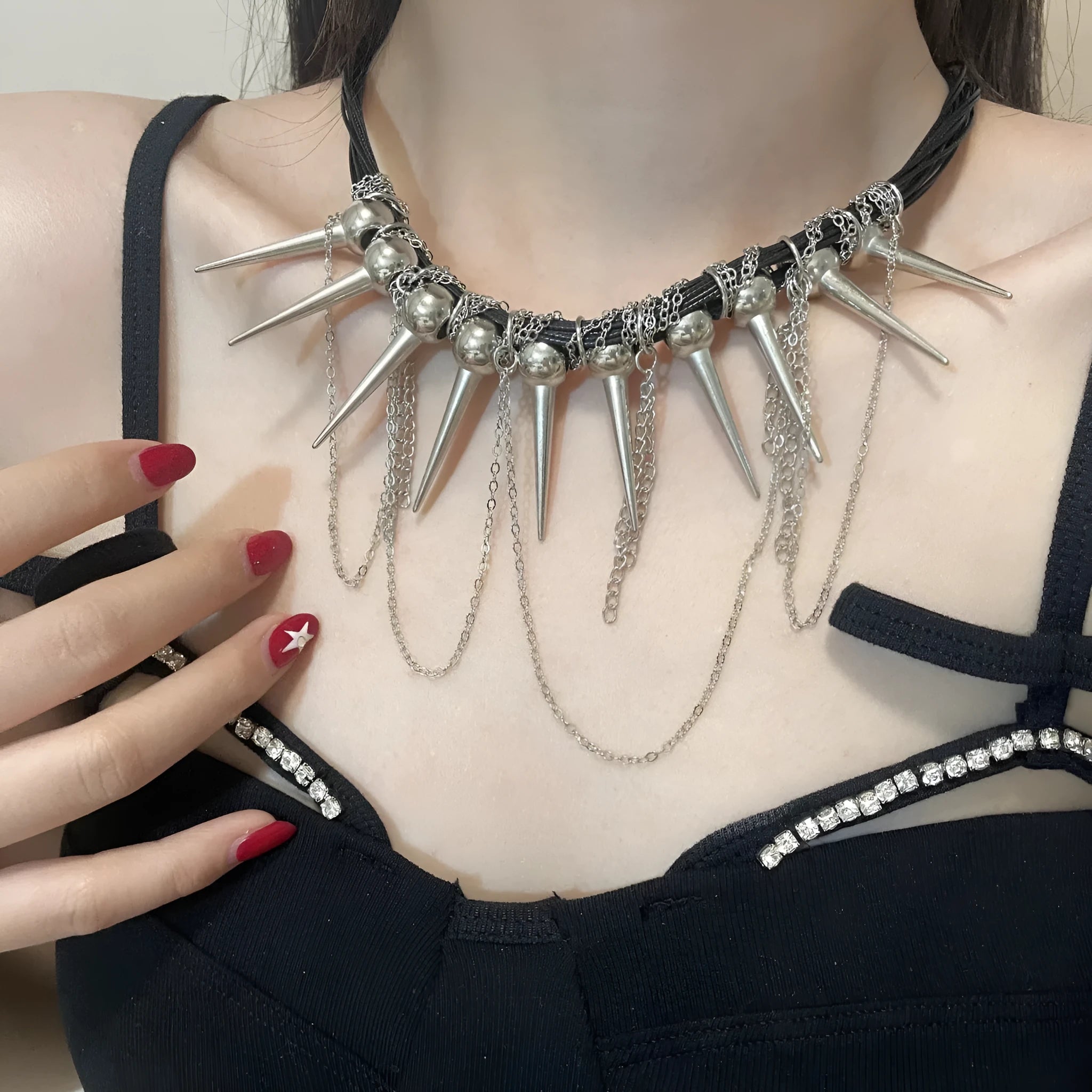 Leather necklace with round beads, a winding tassel, and point rivets in an electroplated picture colour.