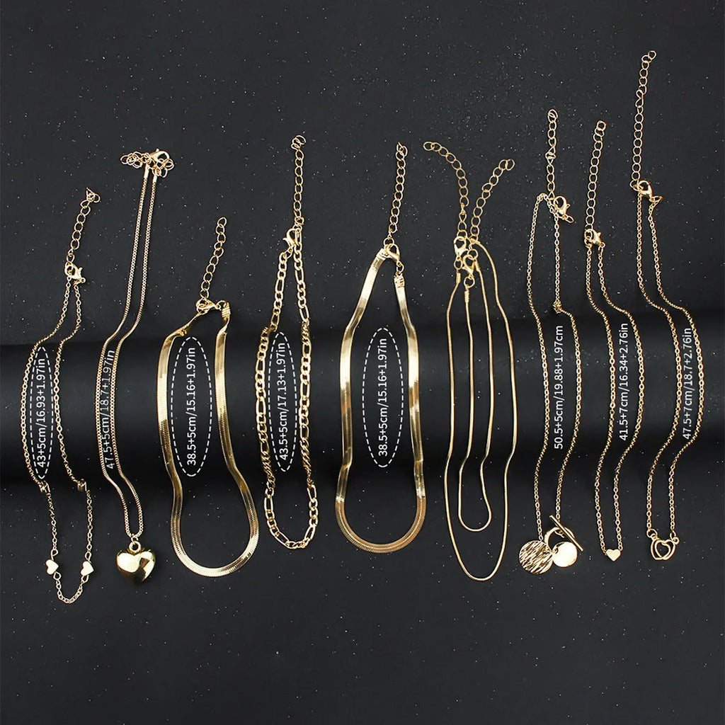 Women's gold necklace set with 10 pendant pieces on adjustable snake bone chain