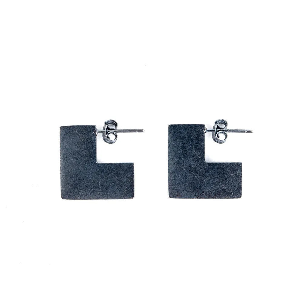 Oxidised black geometric square sterling silver earrings on a white background.