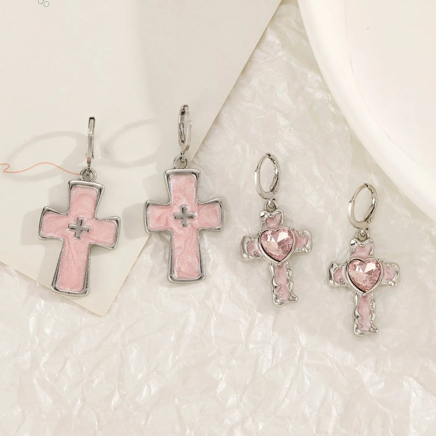 Women's alloy earrings with cross and heart designs in five colour variations including white, black cat, and antique silver