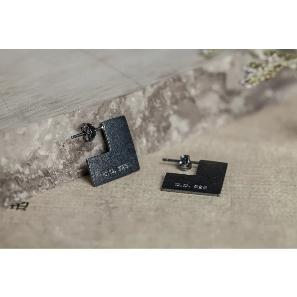 Oxidised black geometric square sterling silver earrings on a white background.