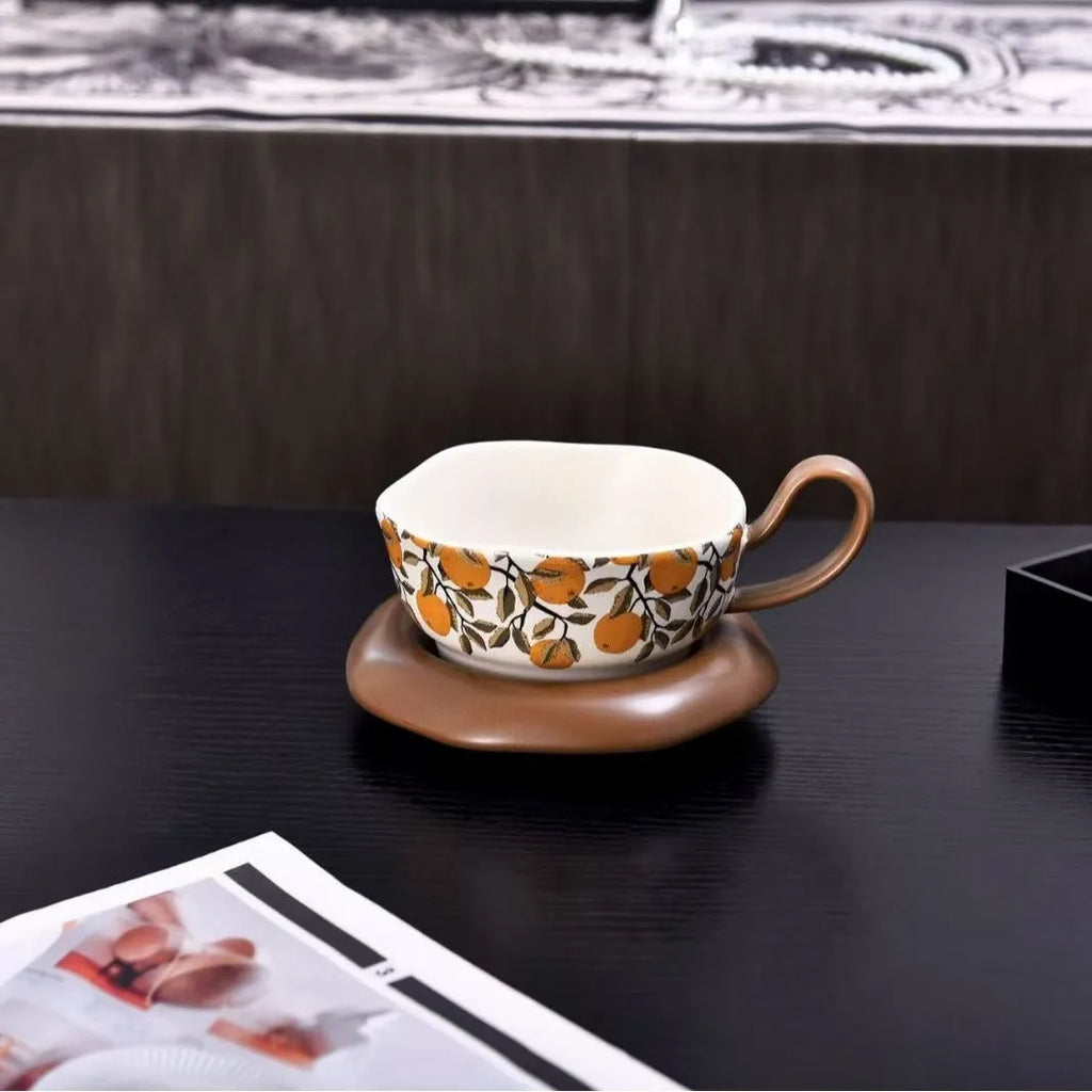 Antique-style black ceramic coffee cup and saucer set on a wooden table