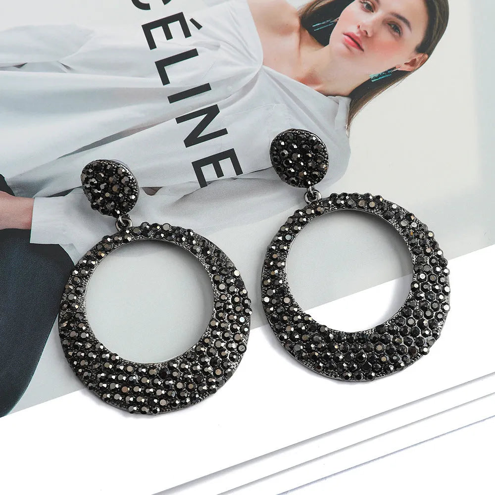 Colourful large round pendant earrings with metal diamond accents in cartoon style