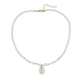 White bead necklace with a mother of pearl conch shell pendant on a regular chain.