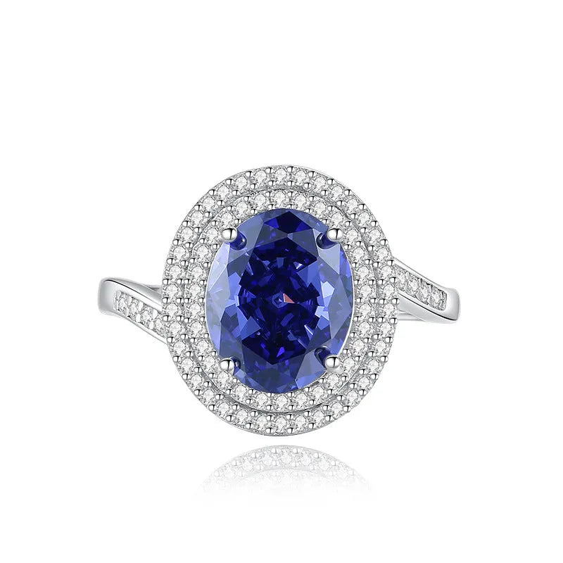 Heart-shaped sterling silver ring with a faceted colour zircon stone on a white background.