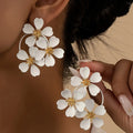 Retro flower-shaped iron earrings for women in black or white with European-American styling