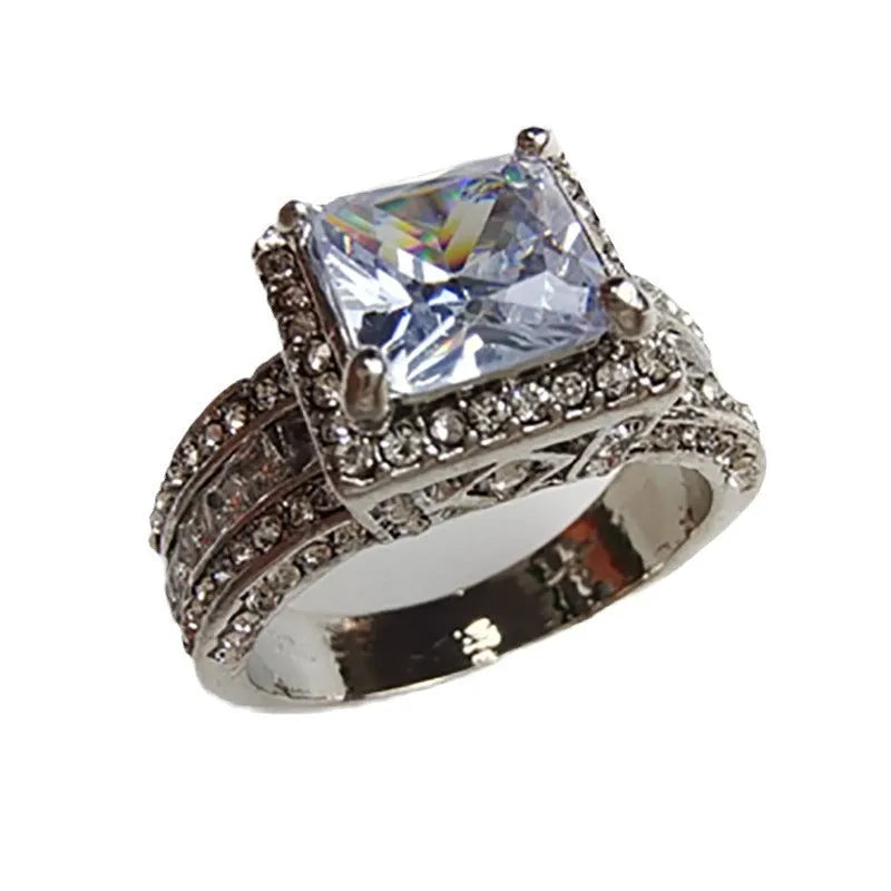 A geometric silver-tone women's ring with round elements, shown in gold and white colour options.