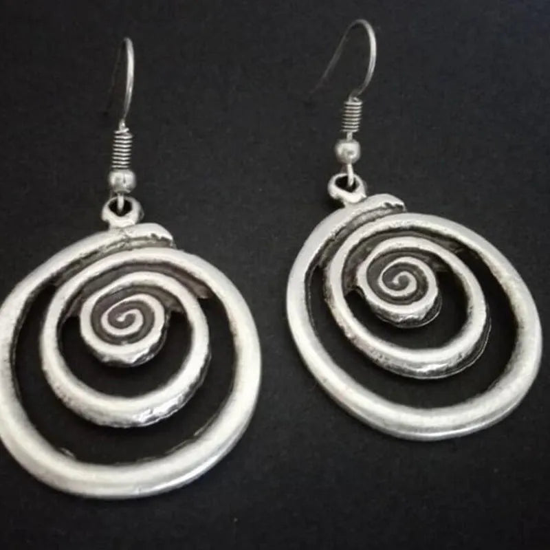 Geometric spiral earrings with distressed silver finish measuring 2.6cm wide by 5cm long