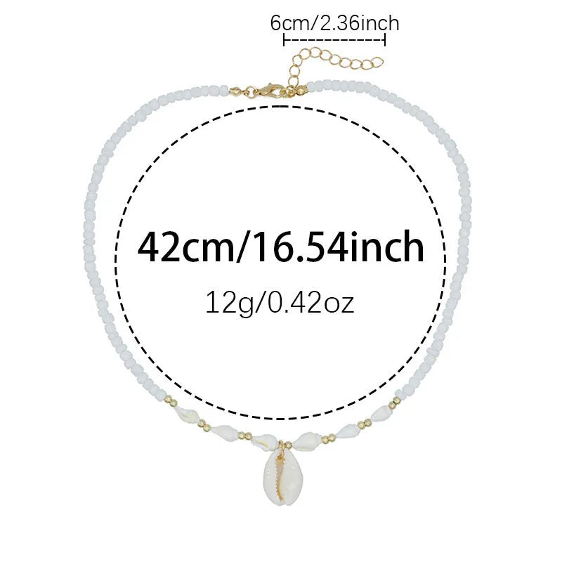 White bead necklace with a mother of pearl conch shell pendant on a regular chain.