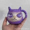 Resin cat cup crystal globe decorative ornament on a desk, shown in purple colour.