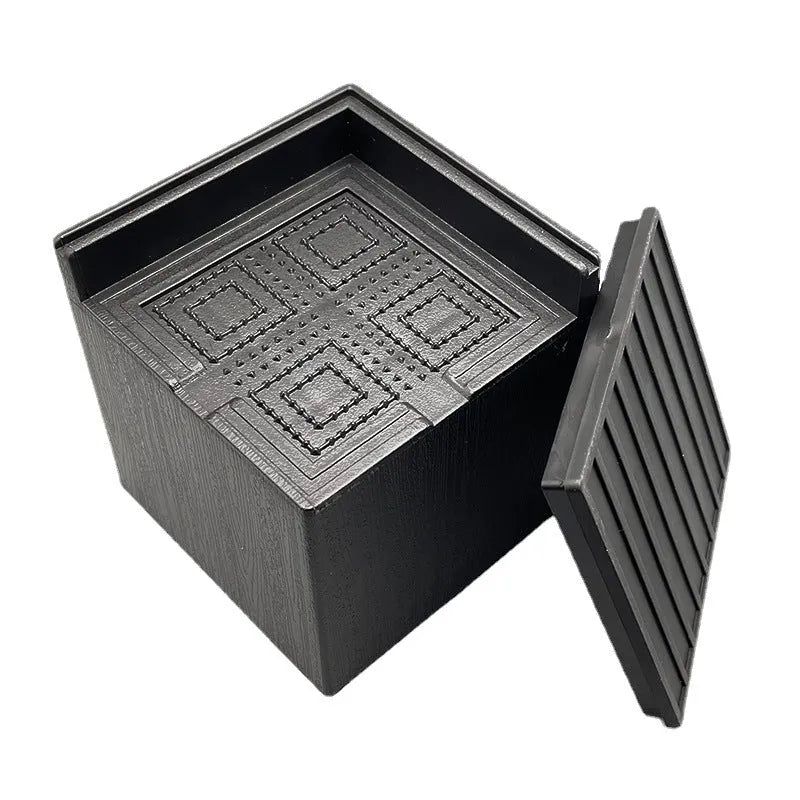 Four black plastic furniture height adjustment mats for bed and sofa legs