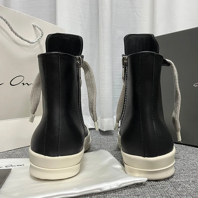 Black high-top leather sneakers with side zipper and round toe on a platform sole.