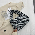 Plush retro shoulder bag in zebra print with single strap and polyester lining