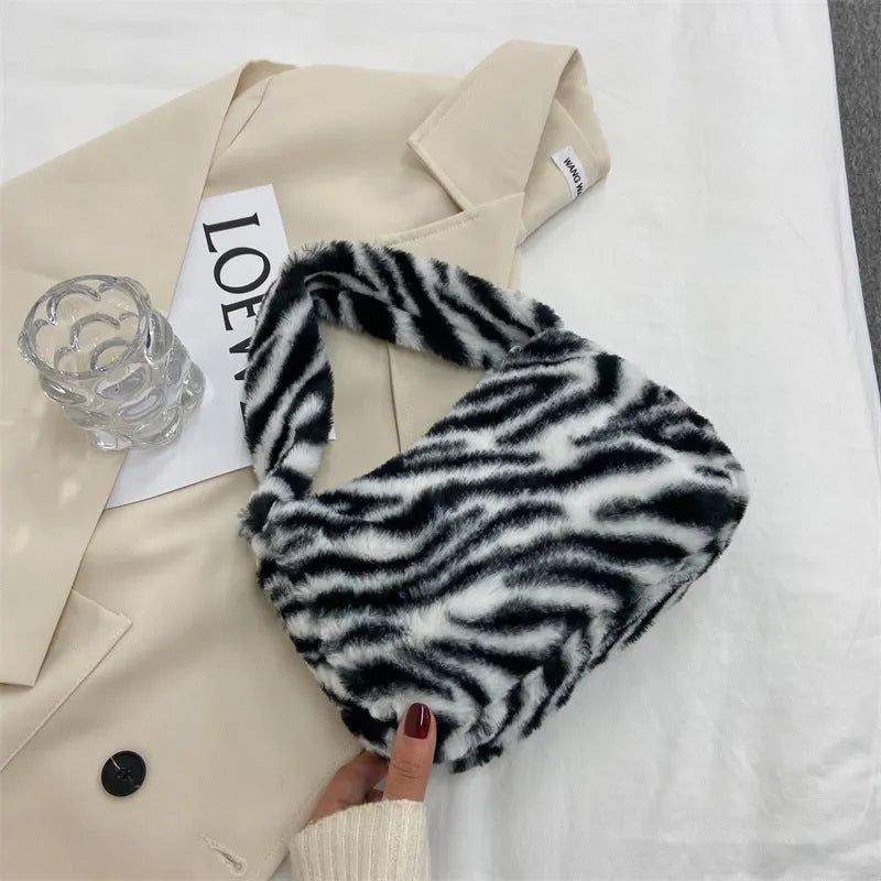 Plush retro shoulder bag in zebra print with single strap and polyester lining
