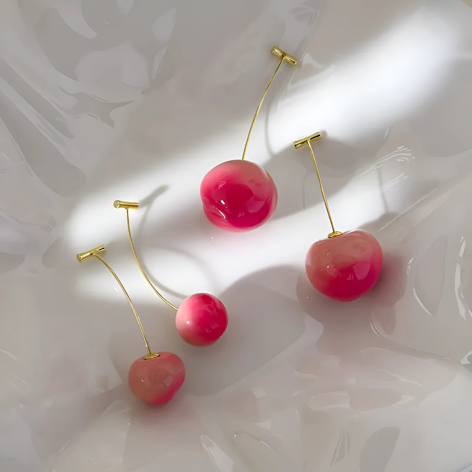 A pair of lightweight acrylic earrings shaped like peaches, shown in small and large size options.