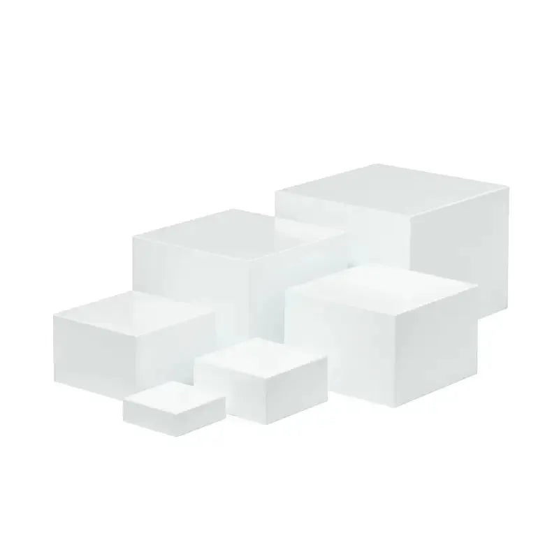 White plastic cube dessert display stand set of six pieces arranged on a table.