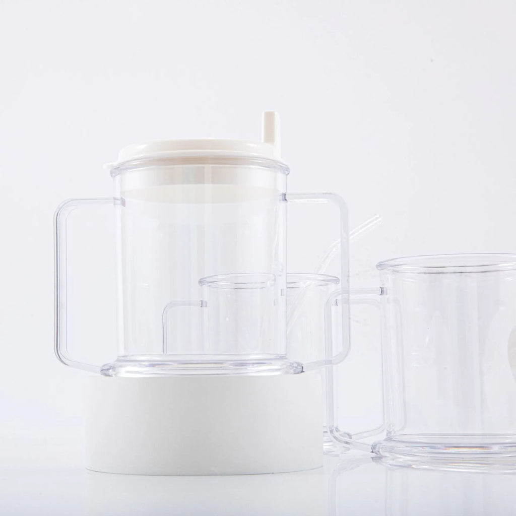 Transparent spill-proof plastic drinking cup with modern design on a plain background.