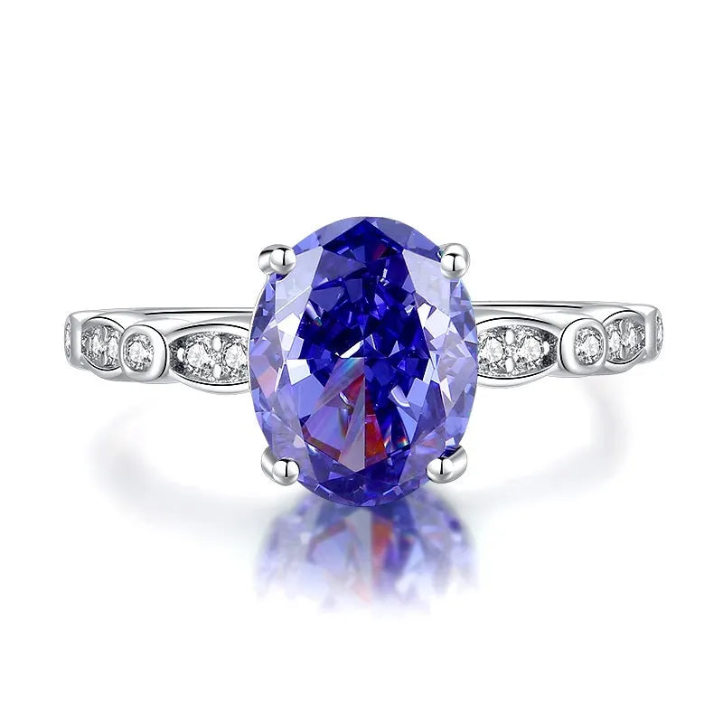 Heart-shaped sterling silver ring with a faceted colour zircon stone on a white background.