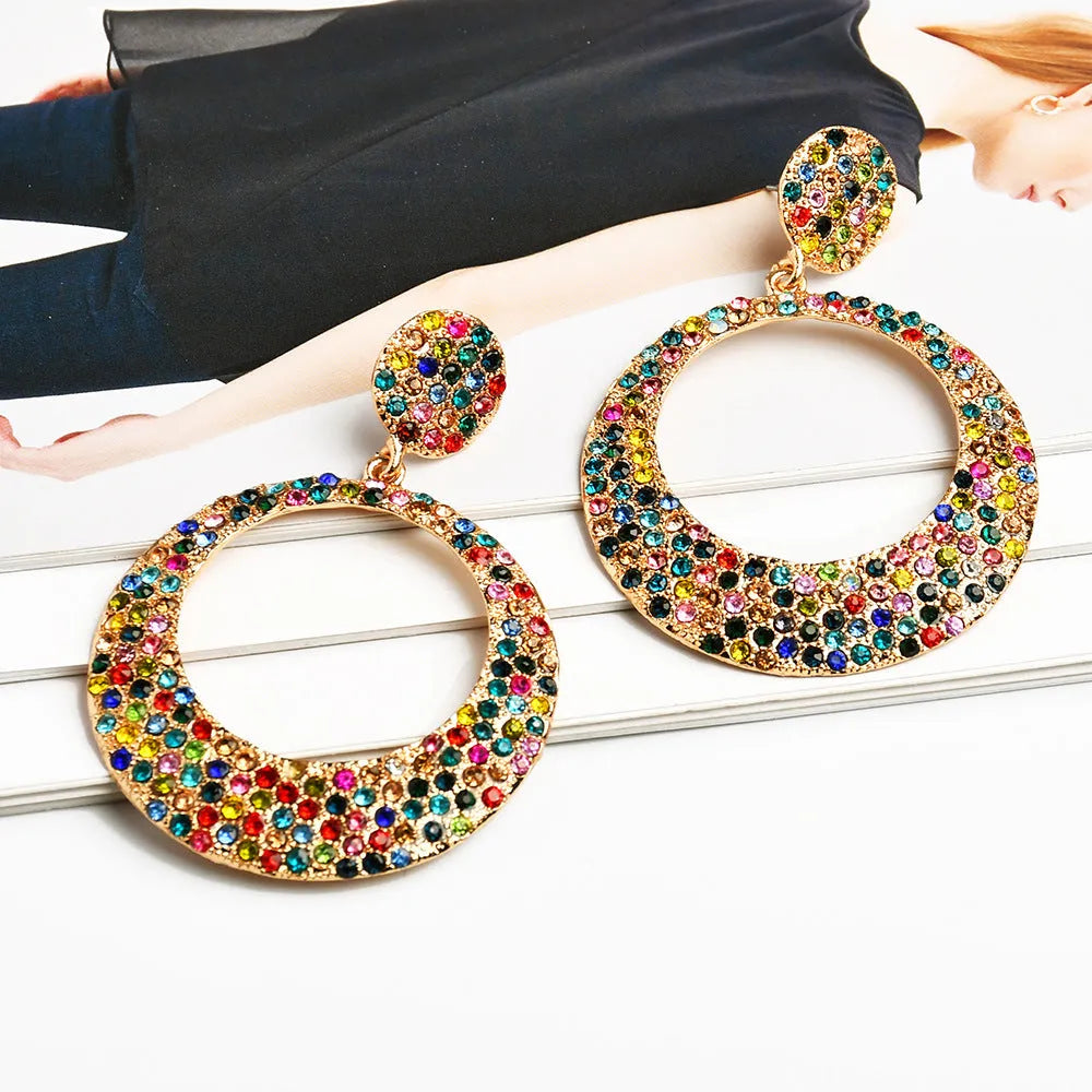 Colourful large round pendant earrings with metal diamond accents in cartoon style