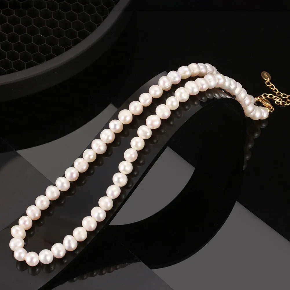 Close-up of a women's adjustable necklace with freshwater pearls on a sterling silver chain.