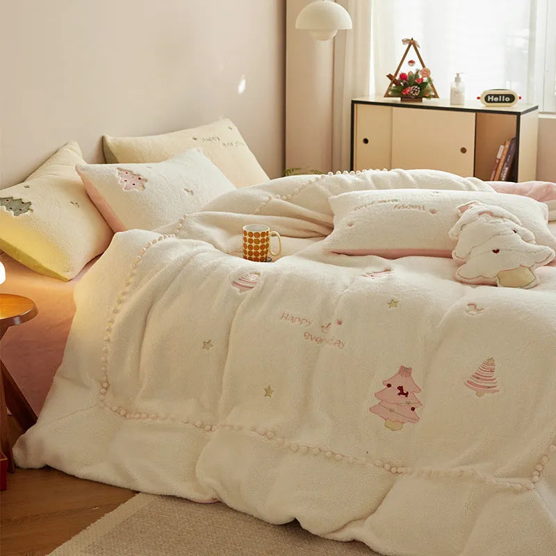 Winter milk fibre princess-style bedding four-piece set with green Christmas tree pattern on a bed.