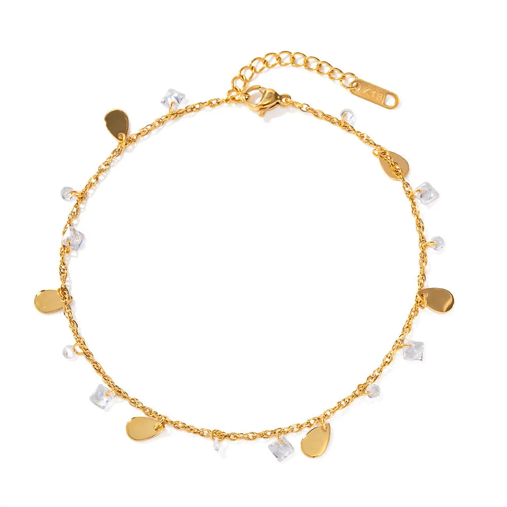 Stainless steel women's anklet with a geometric water drop tassel charm on an ankle.