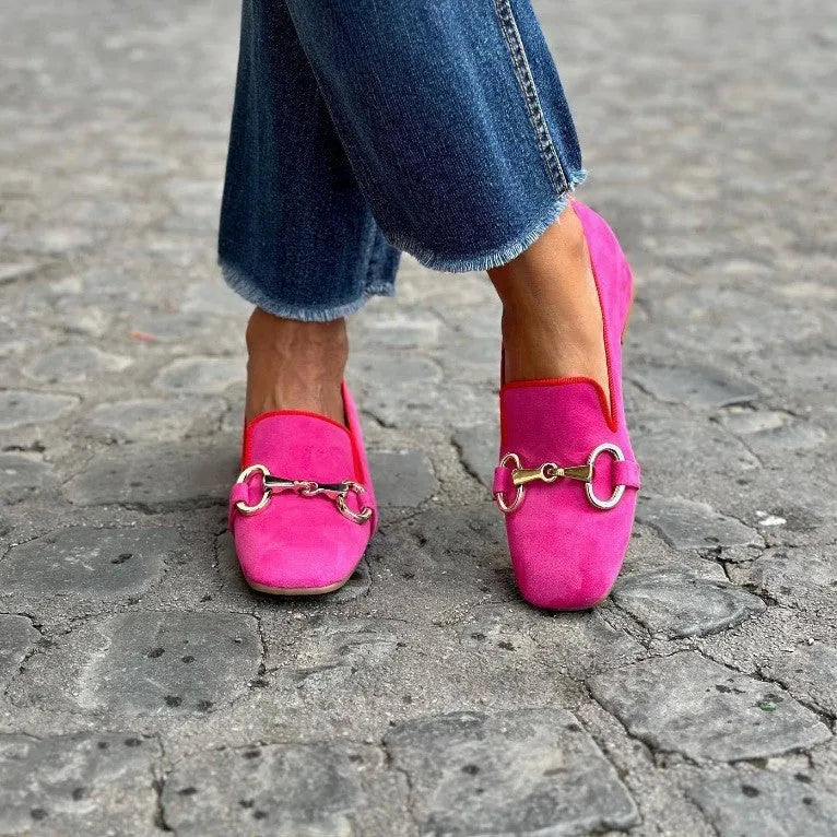 Green suede women's loafers with a round toe and silver metal fastener on the front.