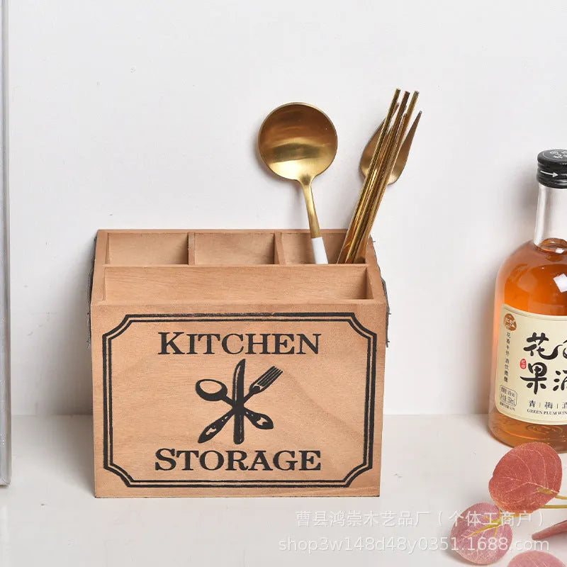 Open wooden kitchen storage box with grid divider for knives, forks, and chopsticks.