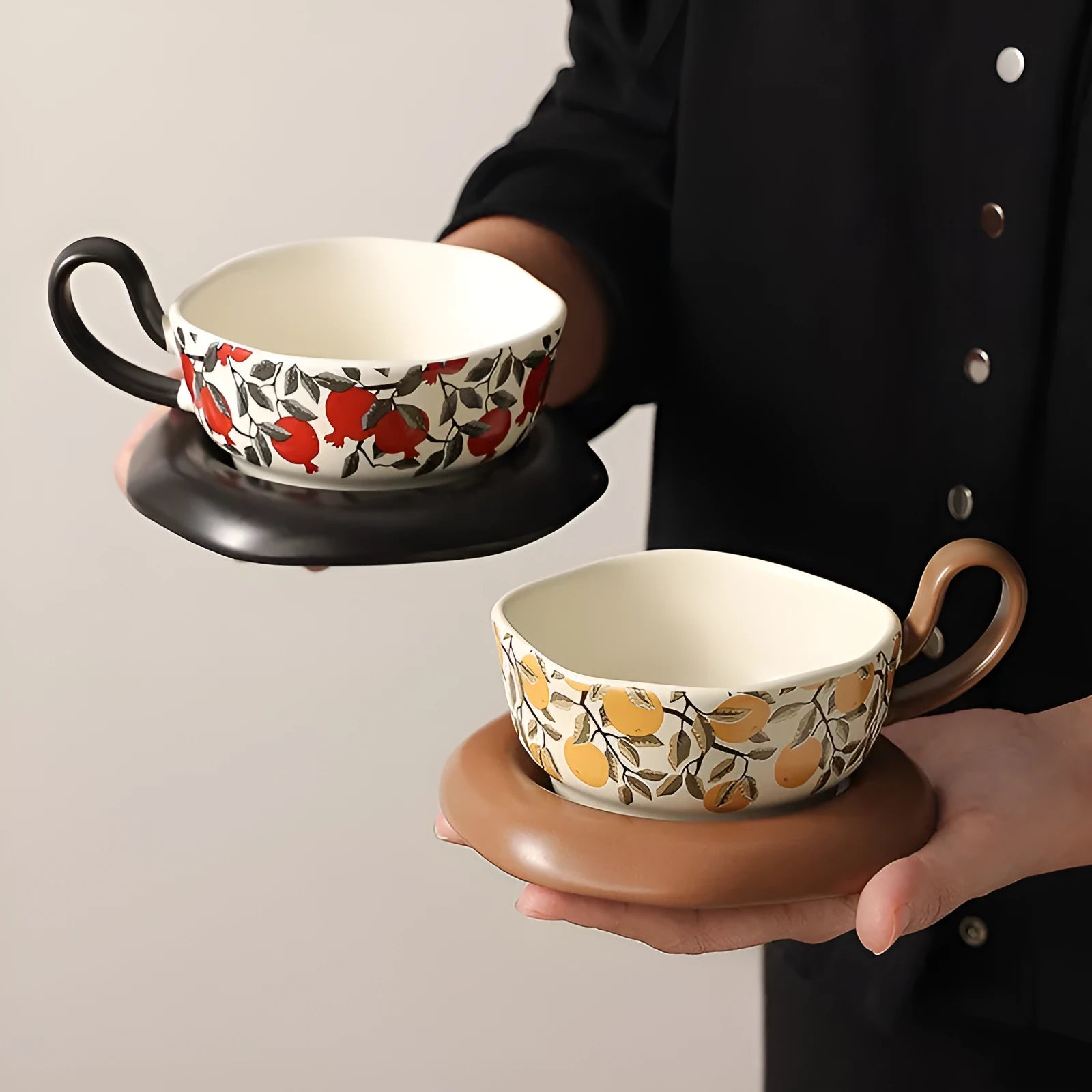 Antique-style black ceramic coffee cup and saucer set on a wooden table