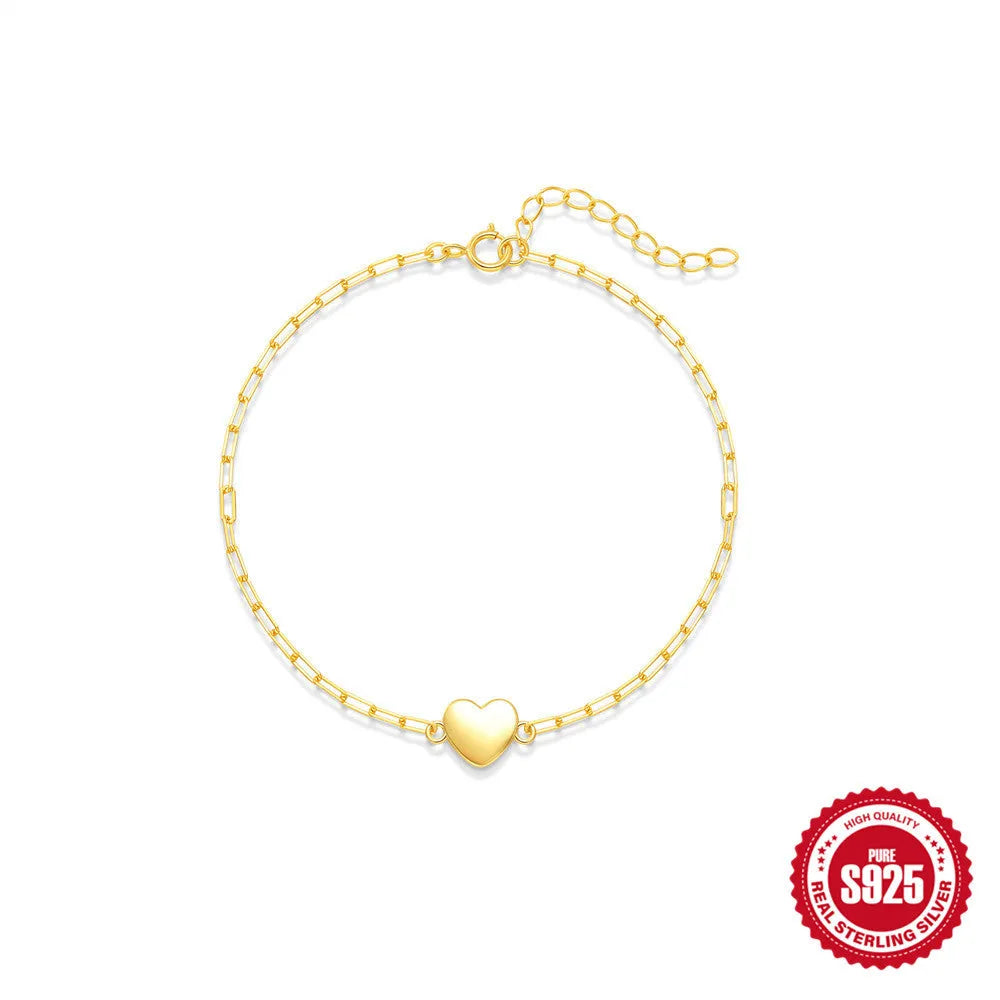 Gold plated S925 sterling silver bracelet with heart charm and geometric clip chain on wrist