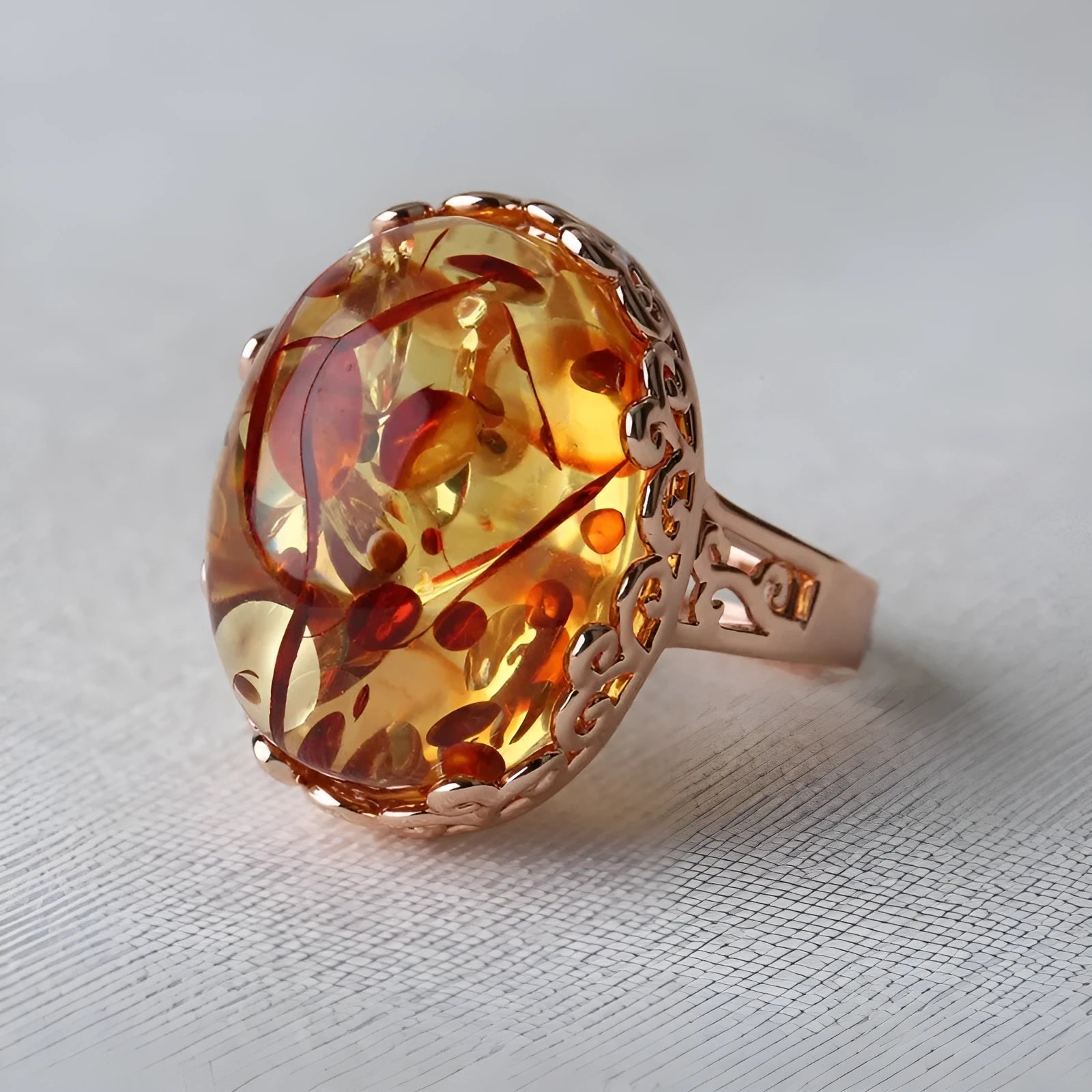Amber ring with beeswax carving detail in New Amber Type A colour on alloy band