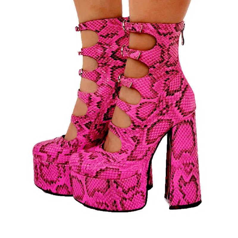 Black women's ankle boot with platform heel, thick sole, and a serpentine strap with buckle closure.