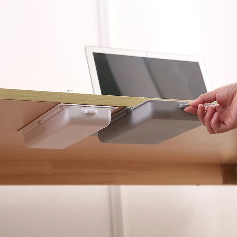 White plastic adhesive under-table storage drawer box with a grid-pattern lid