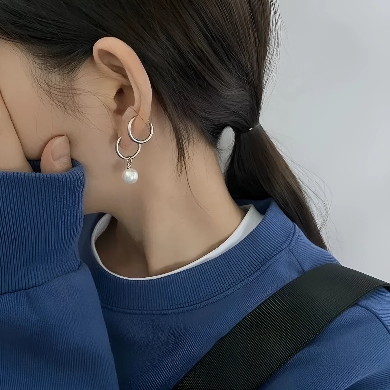 A pair of women's geometric alloy drop earrings with pearl finish and titanium steel posts.