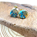 Close-up of handcrafted bohemian stud earrings with an irregular natural stone in colour ER1031 on a simple metal setting.