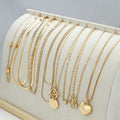 Women's gold necklace set with 10 pendant pieces on adjustable snake bone chain