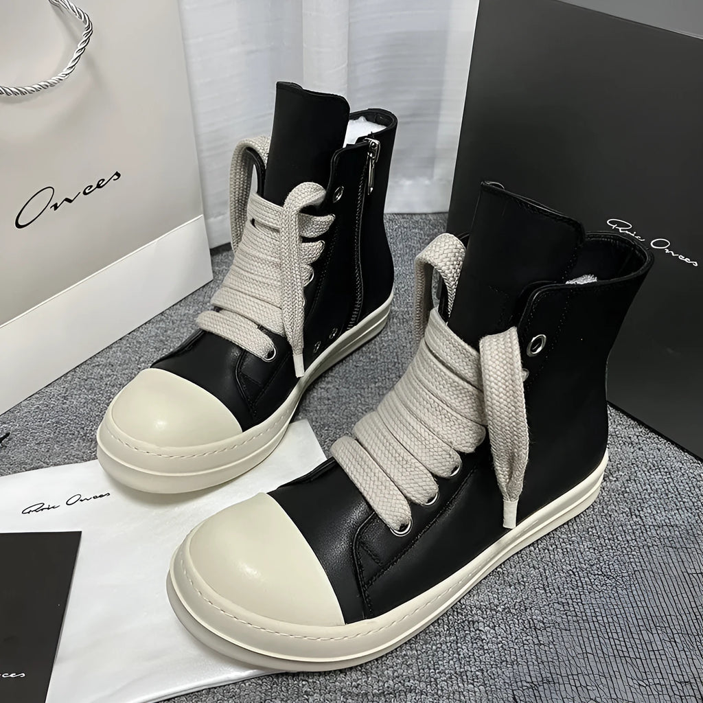 Black high-top leather sneakers with side zipper and round toe on a platform sole.