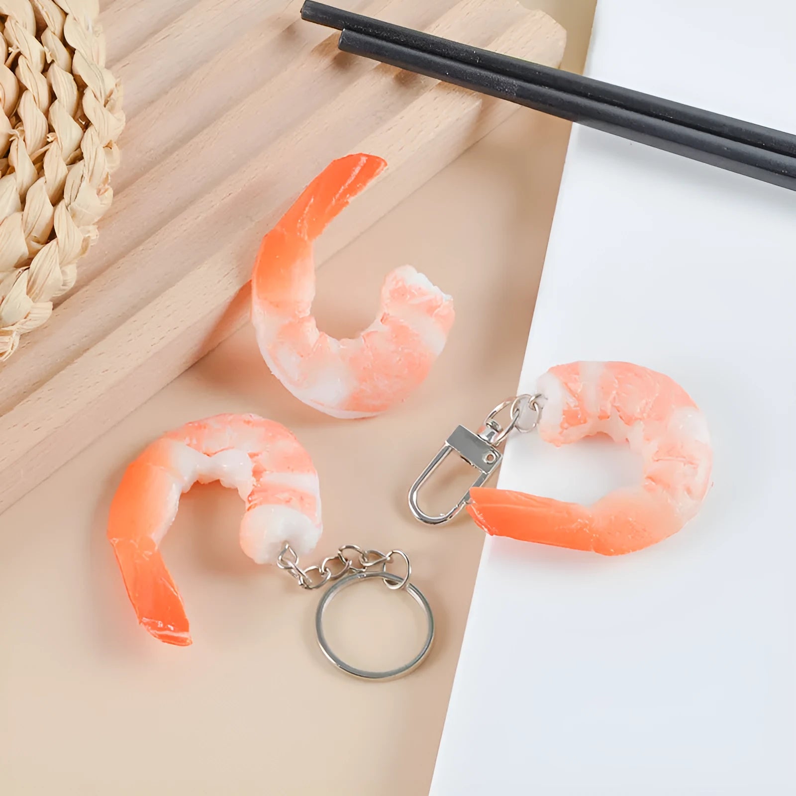 White PVC shrimp simulation keychain with metal door buckle, shown from the side to highlight its 1.5cm thickness.