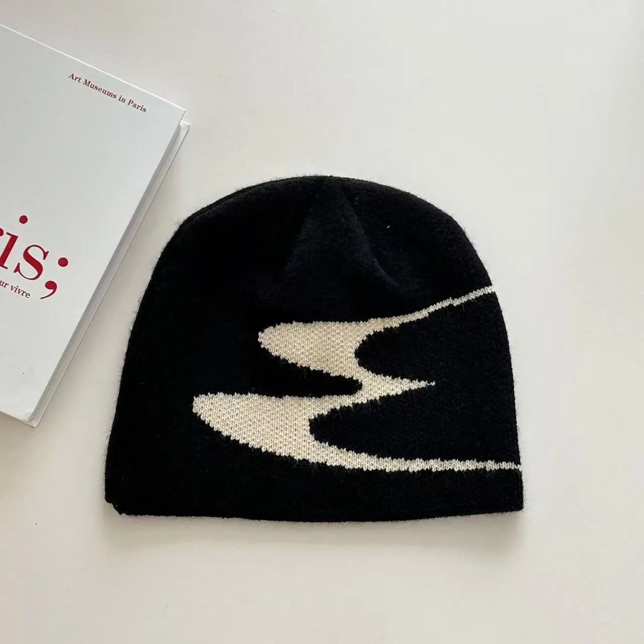 Unisex acrylic knitted beanie hat in black, shown on a head model, size M for 56-58cm circumference.