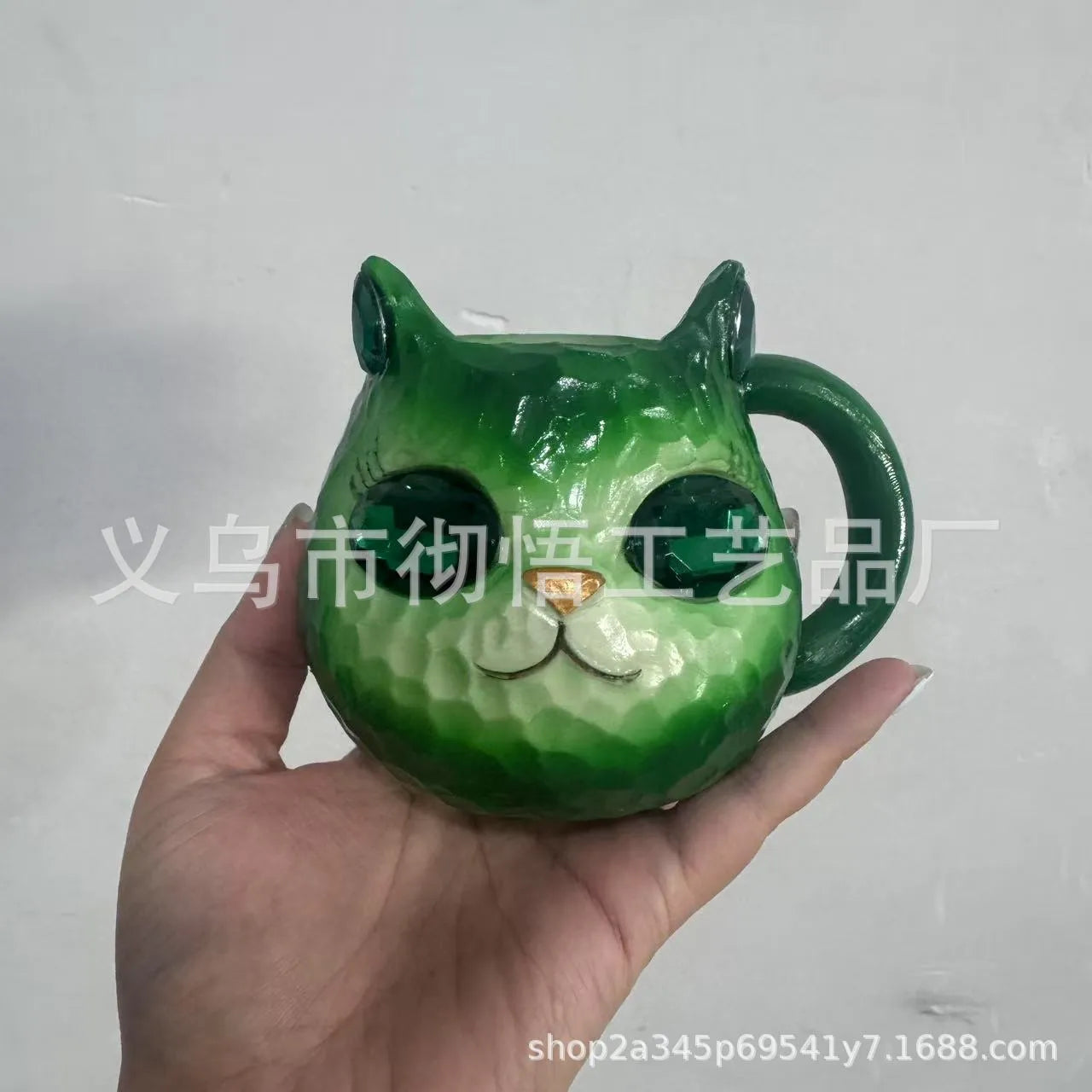 Resin cat cup crystal globe decorative ornament on a desk, shown in purple colour.